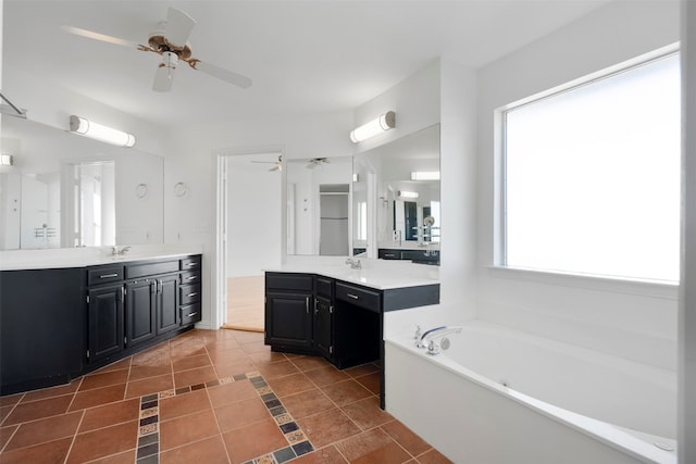 bathroom featuring vanity, tile patterned flooring, and a washtub