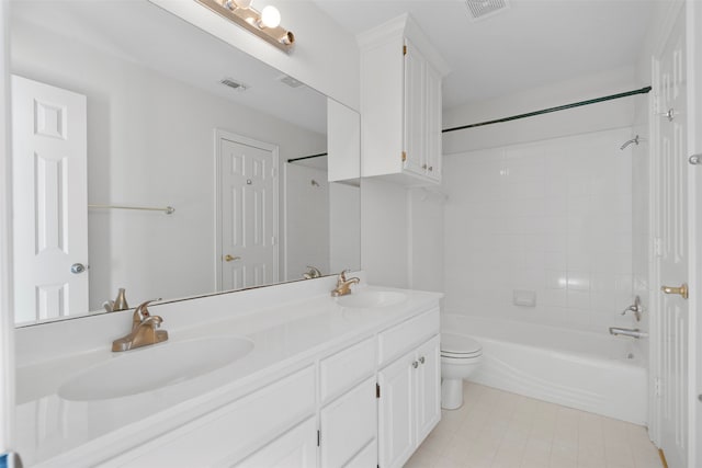 full bathroom featuring toilet, tiled shower / bath combo, and vanity