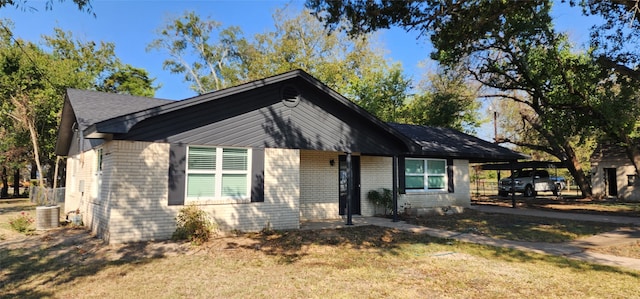 view of front facade with a carport and a front lawn