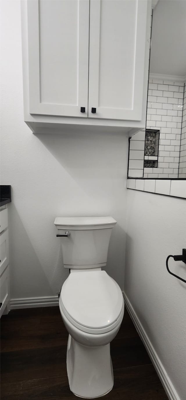 bathroom featuring vanity, toilet, and hardwood / wood-style floors