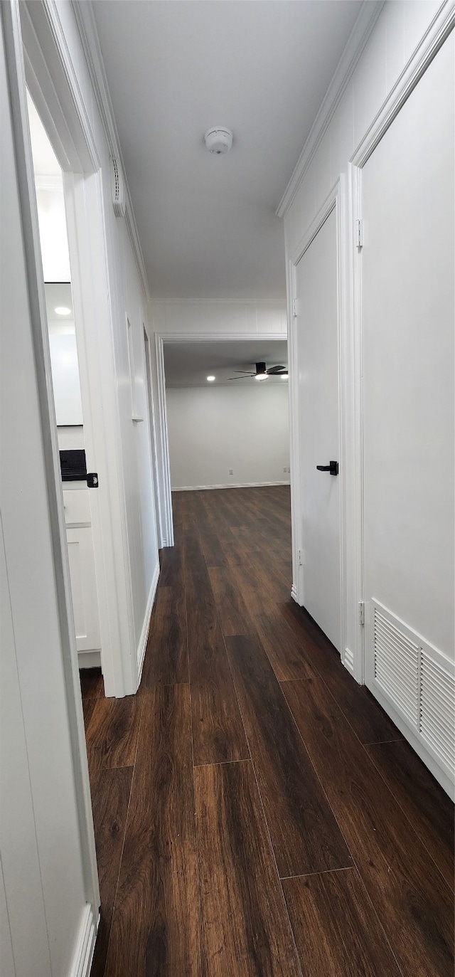 hall featuring crown molding and dark hardwood / wood-style floors