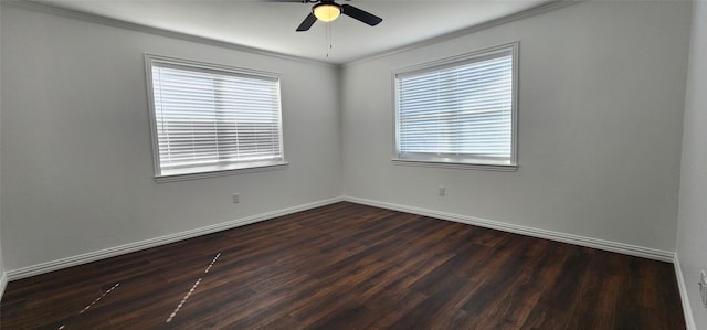 spare room featuring crown molding, plenty of natural light, and dark hardwood / wood-style floors