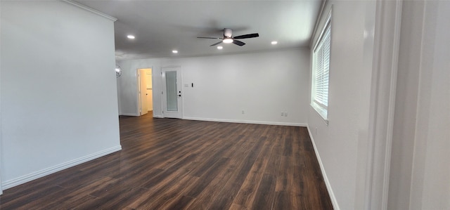 empty room featuring ornamental molding, dark wood-type flooring, and ceiling fan