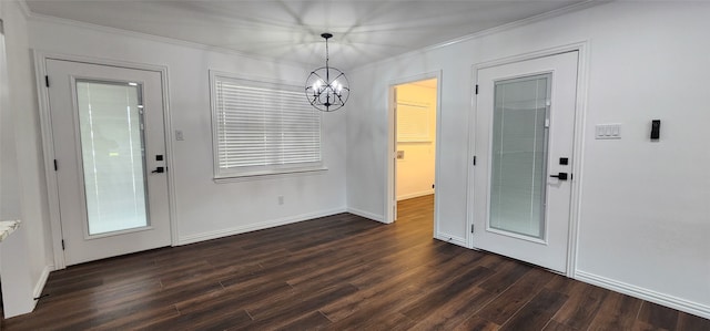 unfurnished dining area featuring crown molding, dark hardwood / wood-style floors, and a chandelier