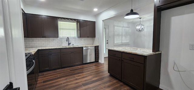 kitchen with appliances with stainless steel finishes, sink, decorative light fixtures, dark wood-type flooring, and decorative backsplash