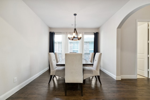 dining room featuring a notable chandelier and dark hardwood / wood-style floors