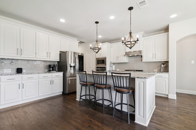 kitchen with a kitchen island with sink, appliances with stainless steel finishes, dark hardwood / wood-style floors, and white cabinets