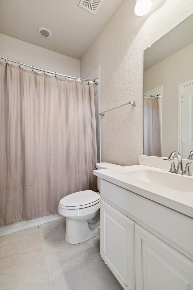 bathroom featuring vanity, toilet, and a shower with curtain