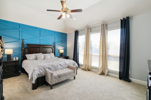 bedroom with lofted ceiling, light colored carpet, and ceiling fan