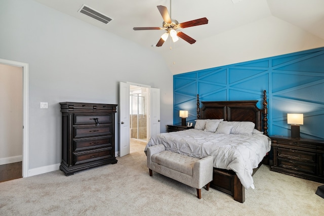 bedroom featuring ensuite bath, light carpet, high vaulted ceiling, and ceiling fan