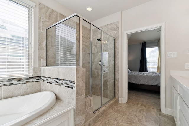 bathroom with vanity and independent shower and bath