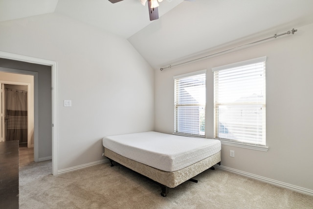 bedroom with lofted ceiling, light carpet, and ceiling fan