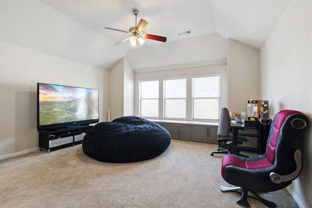 sitting room with ceiling fan, lofted ceiling, and light colored carpet