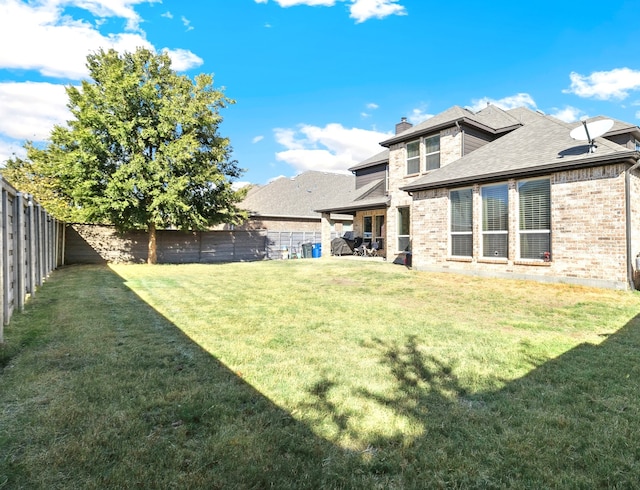 back of house with a yard