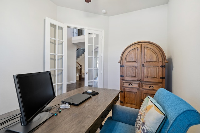 home office with french doors and hardwood / wood-style floors