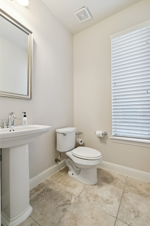 bathroom featuring toilet and tile patterned floors