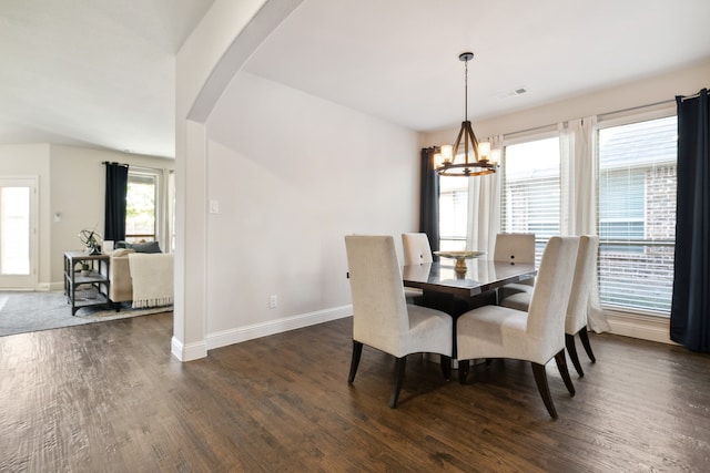 dining room featuring a notable chandelier and dark hardwood / wood-style flooring