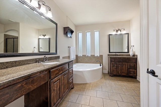 bathroom featuring vanity, tile patterned floors, and shower with separate bathtub