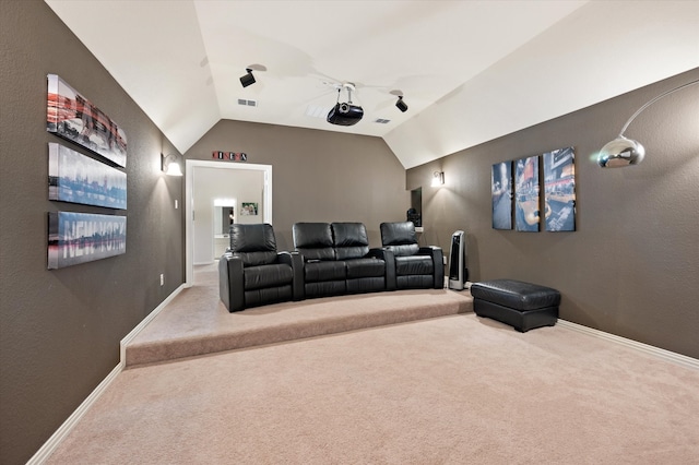 cinema with lofted ceiling and carpet floors