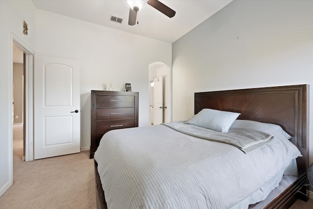 bedroom with ceiling fan, lofted ceiling, and light colored carpet