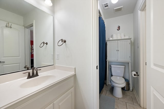 bathroom featuring vanity, toilet, and tile patterned floors