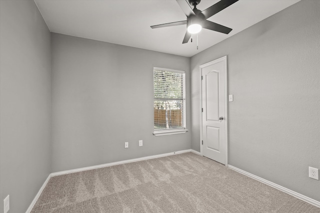 carpeted empty room featuring ceiling fan