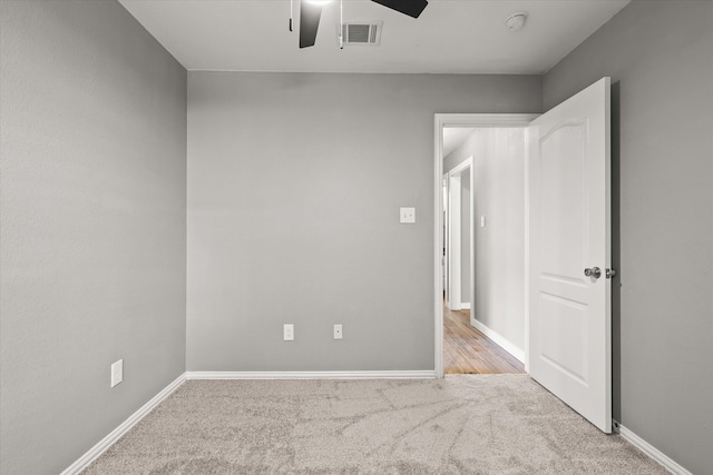 carpeted empty room with ceiling fan