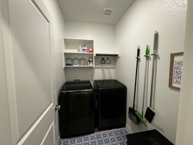 washroom with independent washer and dryer