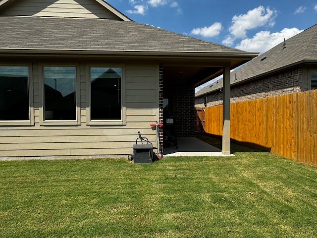 back of house featuring a patio area and a lawn