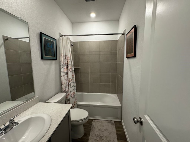 full bathroom featuring toilet, shower / tub combo with curtain, hardwood / wood-style flooring, and vanity