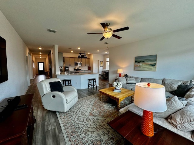 living room featuring a wealth of natural light, hardwood / wood-style flooring, and ceiling fan