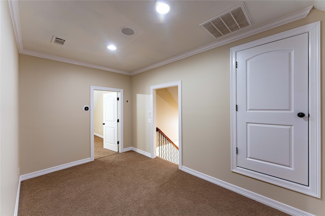 carpeted empty room with crown molding