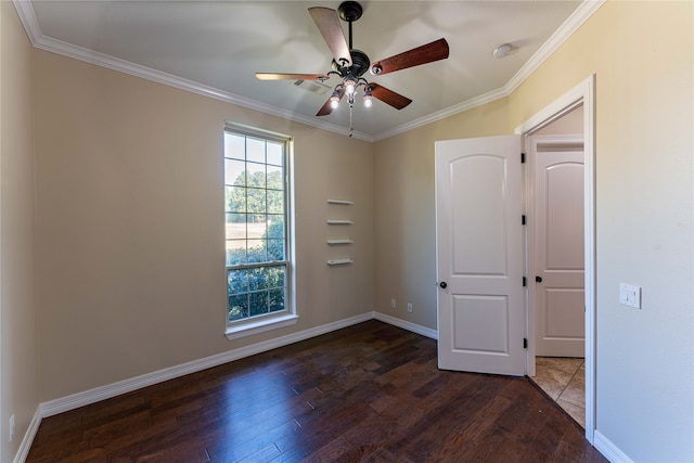 empty room with crown molding, dark wood-type flooring, and ceiling fan