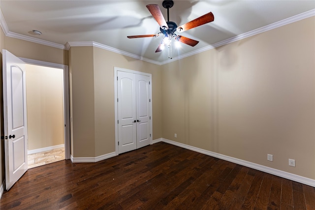 unfurnished bedroom featuring ornamental molding, dark hardwood / wood-style floors, and ceiling fan