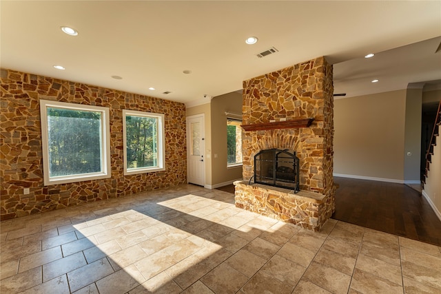 unfurnished living room with a fireplace and wood-type flooring