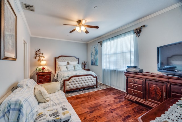 bedroom featuring dark wood-type flooring, ceiling fan, and crown molding