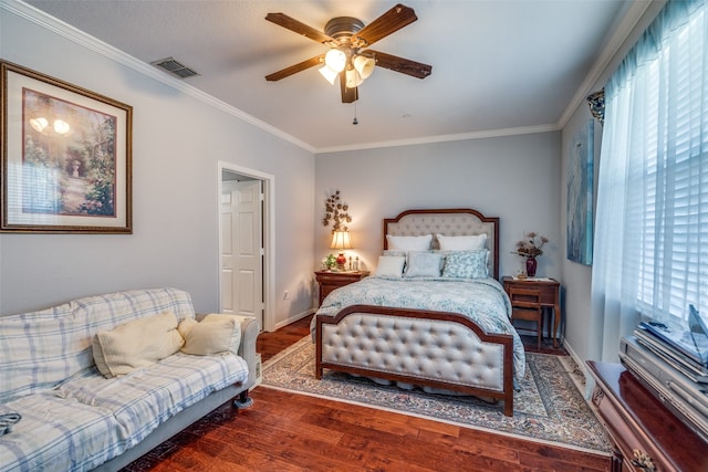 bedroom with dark hardwood / wood-style flooring, ornamental molding, and ceiling fan