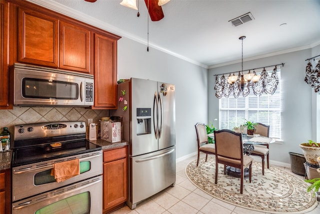 kitchen featuring light tile patterned floors, decorative backsplash, appliances with stainless steel finishes, and ornamental molding