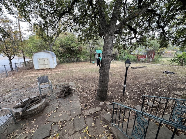 view of yard with a shed and a patio area