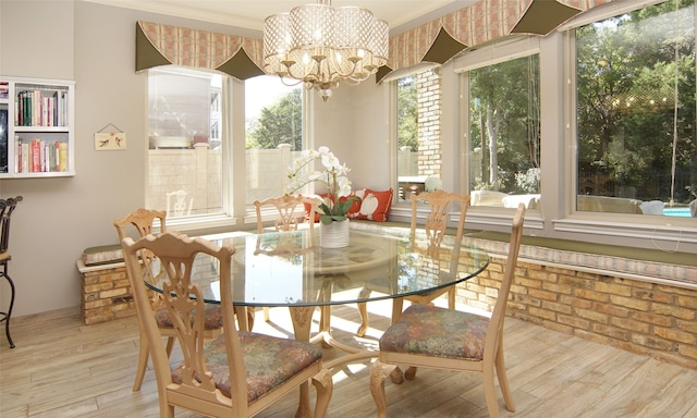 dining space featuring light hardwood / wood-style floors, a notable chandelier, and ornamental molding