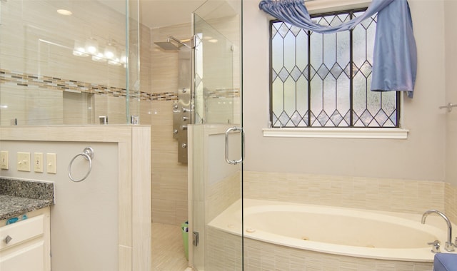 bathroom featuring vanity and shower with separate bathtub