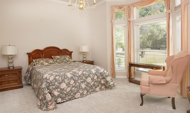 bedroom featuring ornamental molding, a chandelier, and light carpet