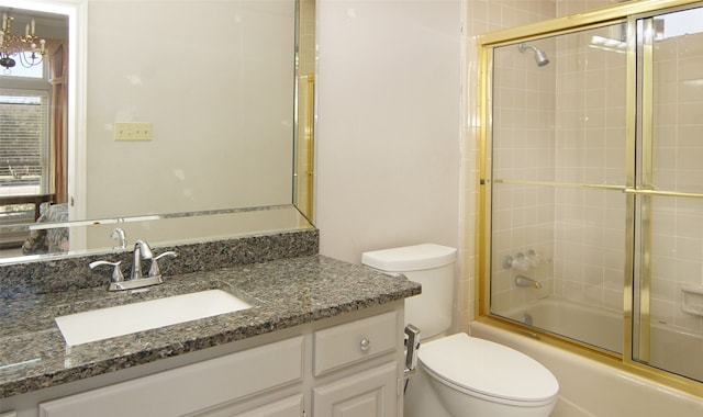 full bathroom with toilet, bath / shower combo with glass door, and vanity