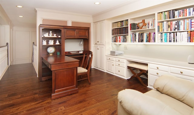 home office with built in desk, crown molding, and dark hardwood / wood-style floors