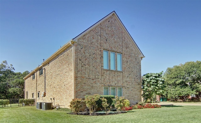 view of side of home with a lawn