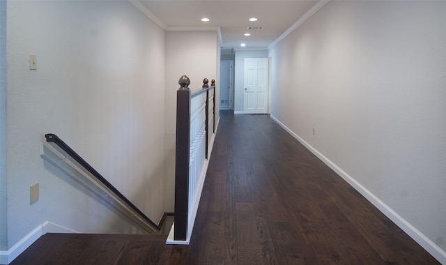 corridor featuring dark wood-type flooring and crown molding