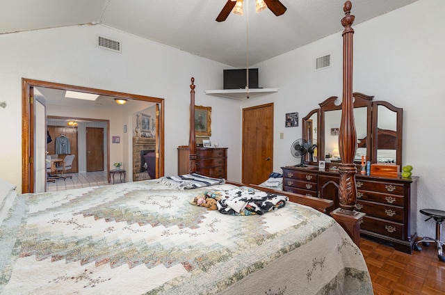 bedroom with ceiling fan, dark parquet floors, and lofted ceiling