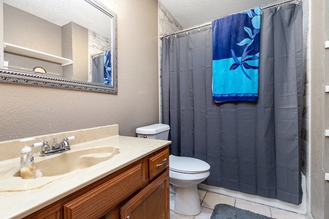 full bathroom featuring toilet, tile patterned flooring, shower / tub combo, vanity, and a textured ceiling