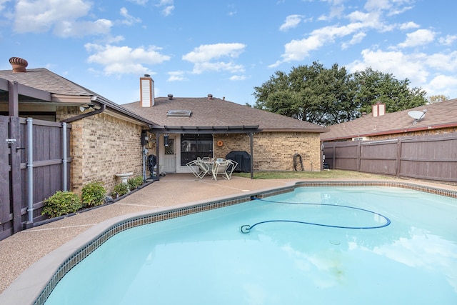 view of swimming pool with a patio area