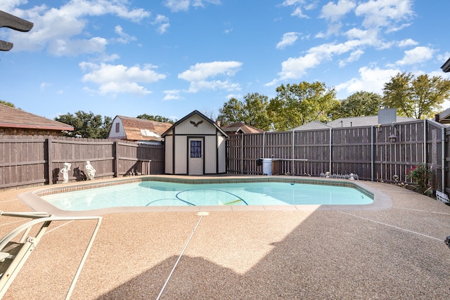 view of pool with a storage shed and a patio area